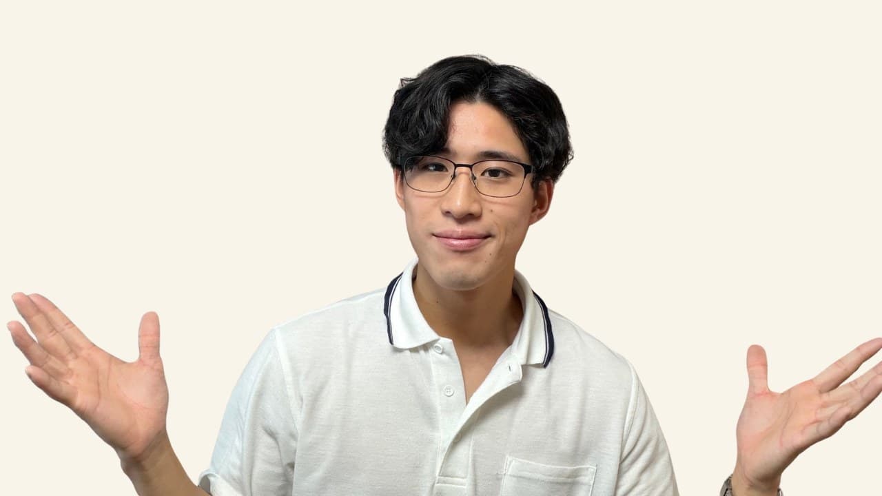 Tetsu, a Japanese teacher, smiling with open hands against a cream background